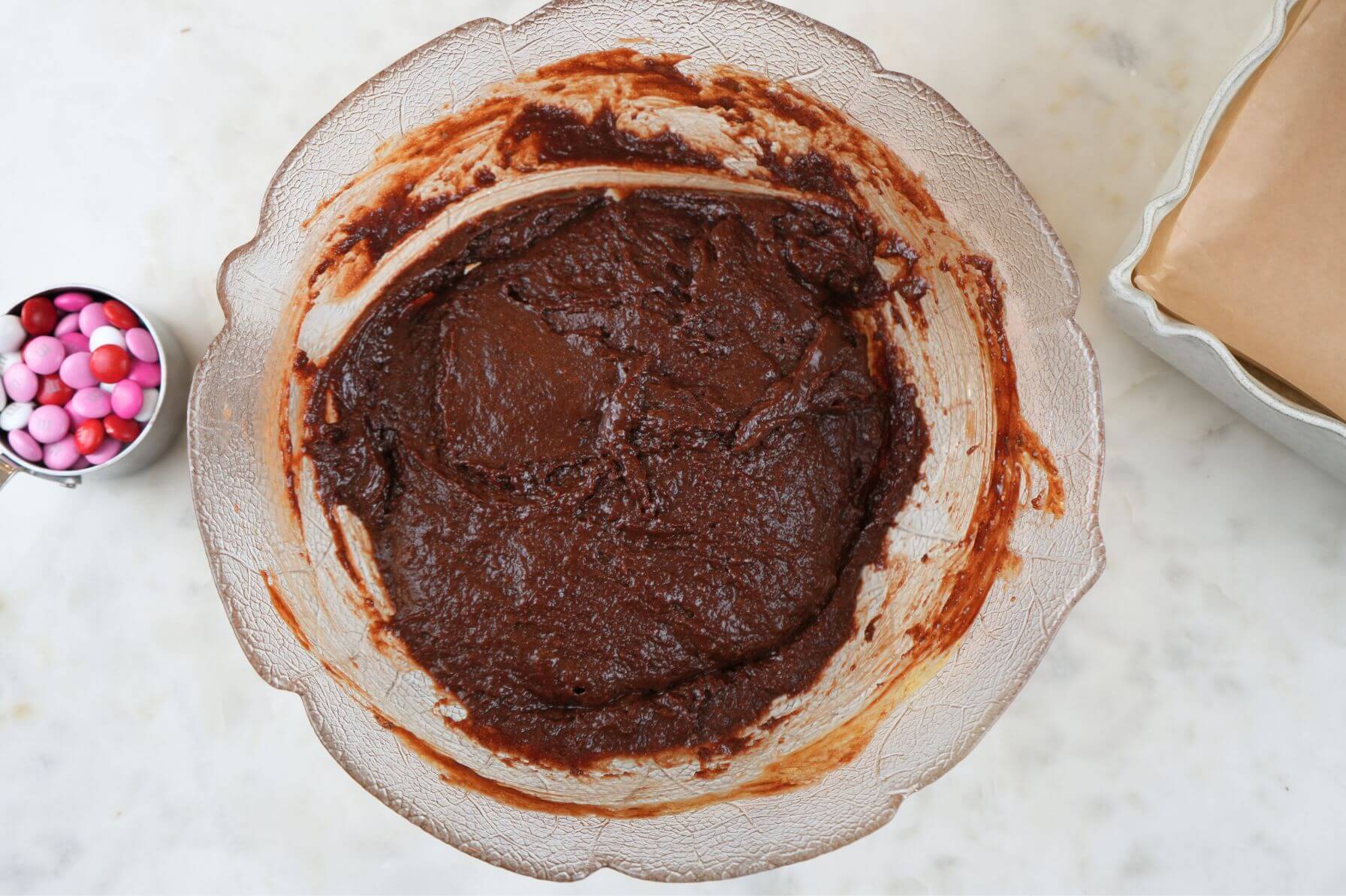 A mixing bowl filled with thick chocolate brownie batter.