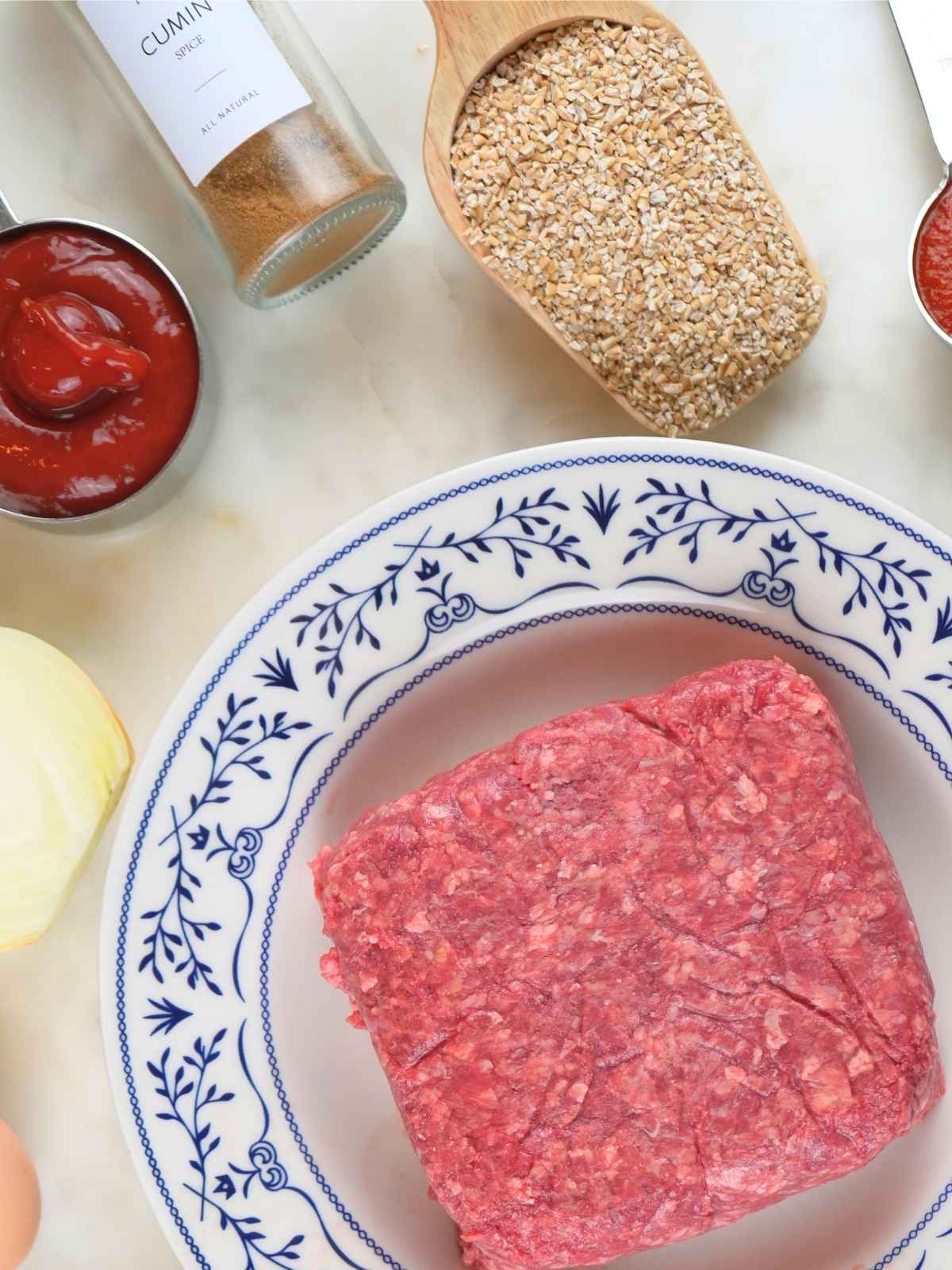 Ground beef and ingredients displayed on counter.