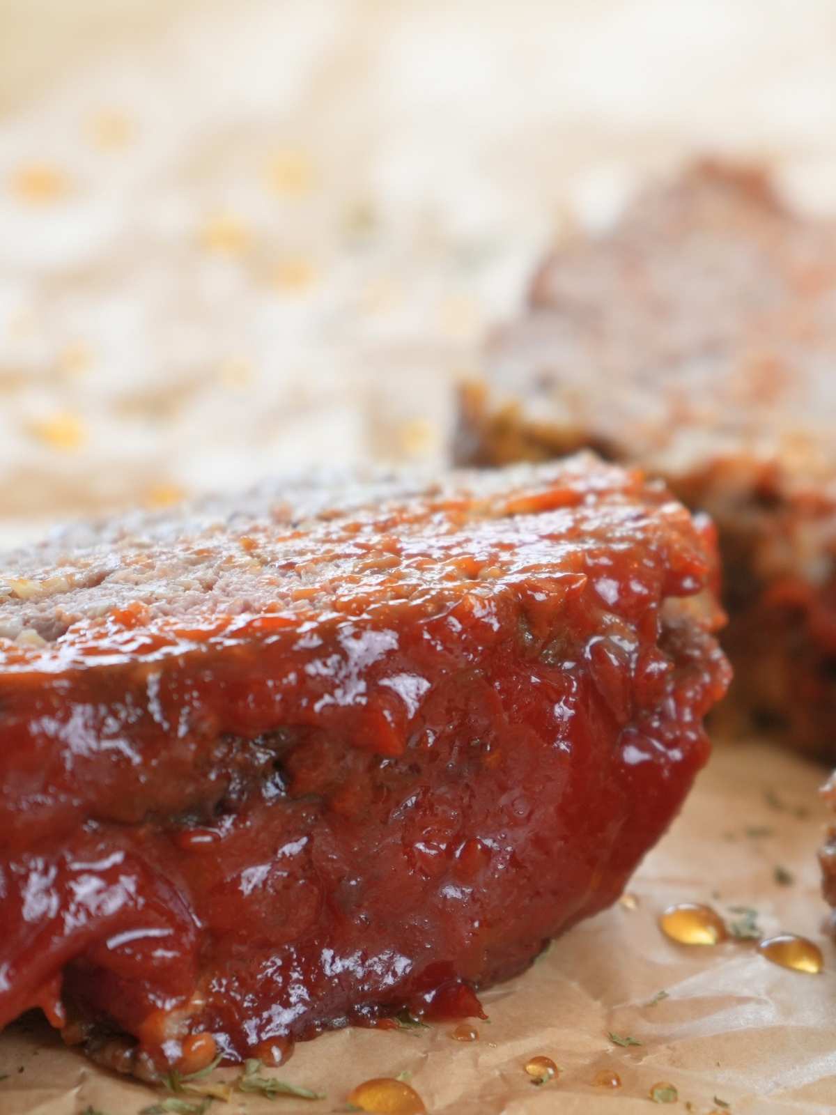 Meatloaf on parchment paper drizzled with honey.