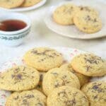 Plates of sourdough London Fog cookies surrounded by cups of tea.