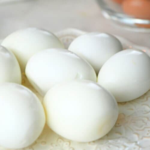 Peeled hard boiled eggs displayed on a decorative plate