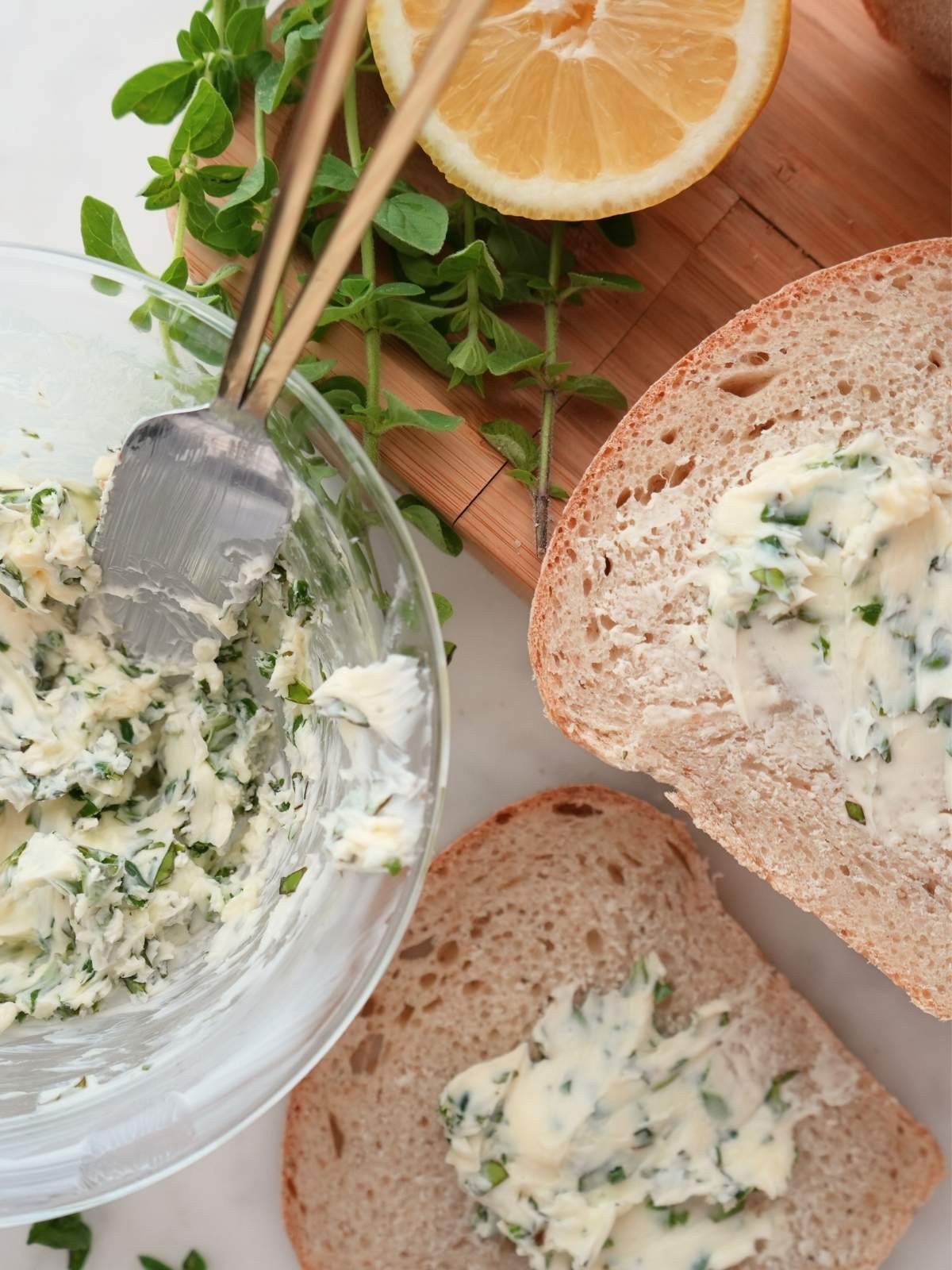 Herb butter in a bowl and spread on bread.