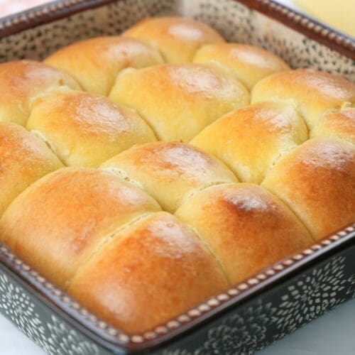Sourdough brioche rolls in a baking dish.