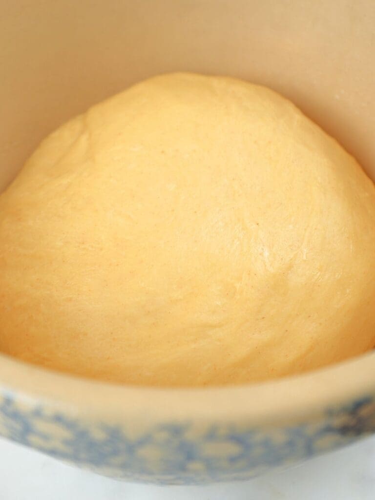 Sourdough brioche dough in a bowl for bulk fermenting.
