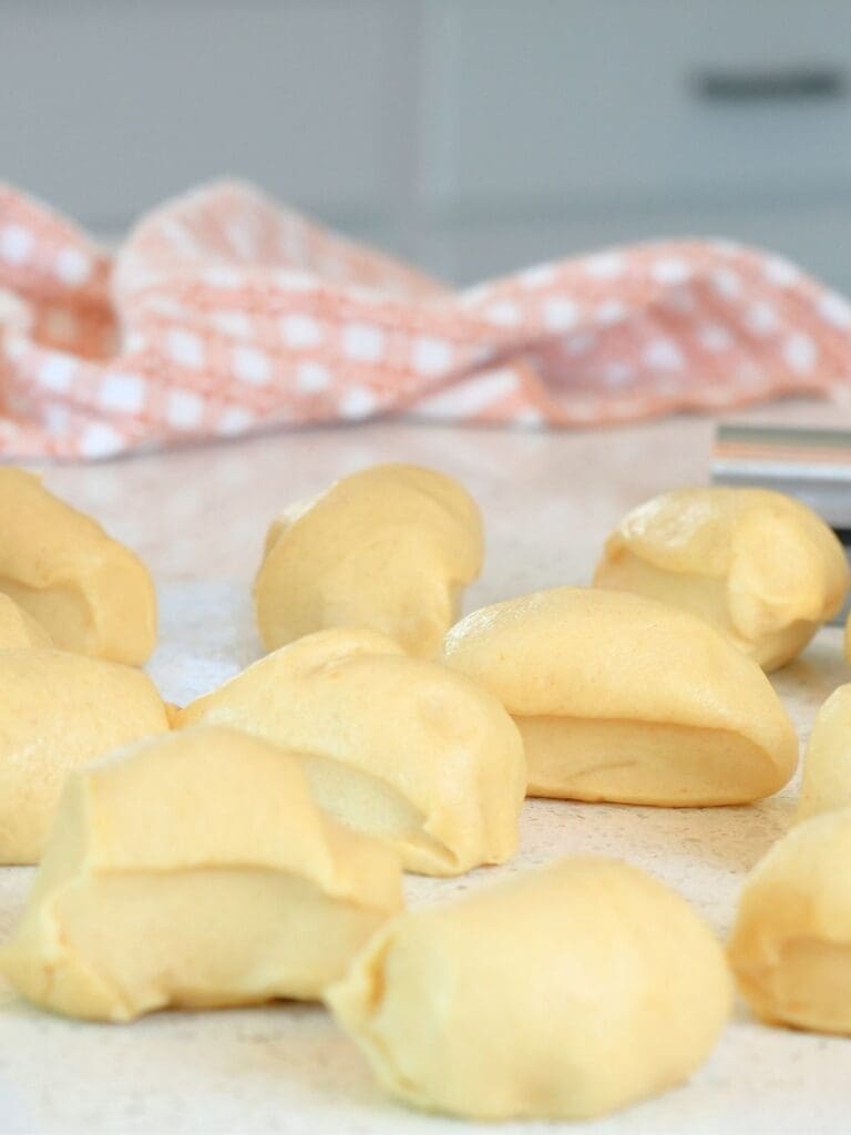 Dough divided into equal portions on a counter.