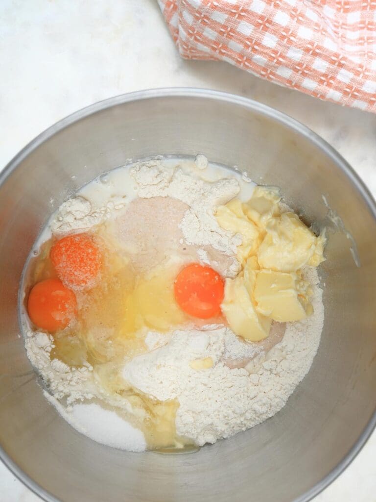 Sourdough brioche ingredients in a stand mixer bowl
