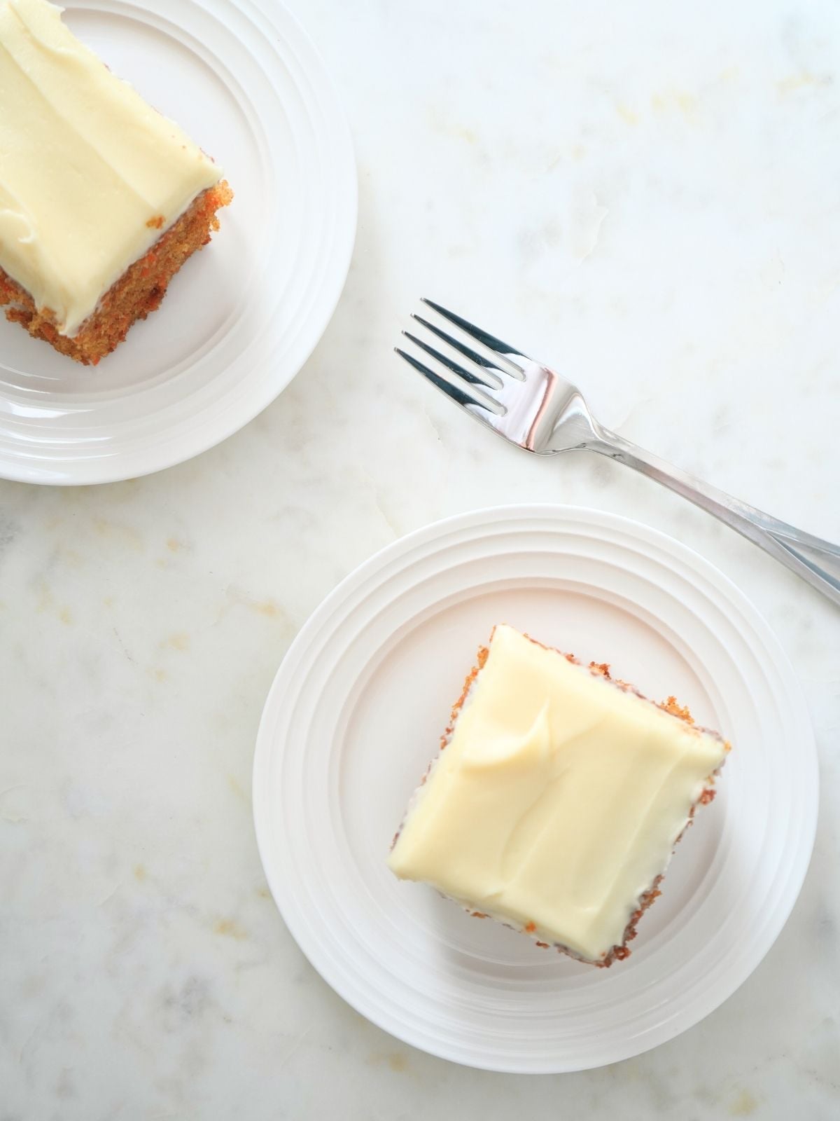 Slices of sourdough carrot cake on plates.