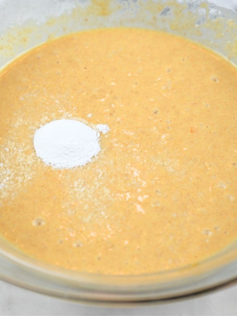Sourdough discard pancake batter with baking powder and salt on top.