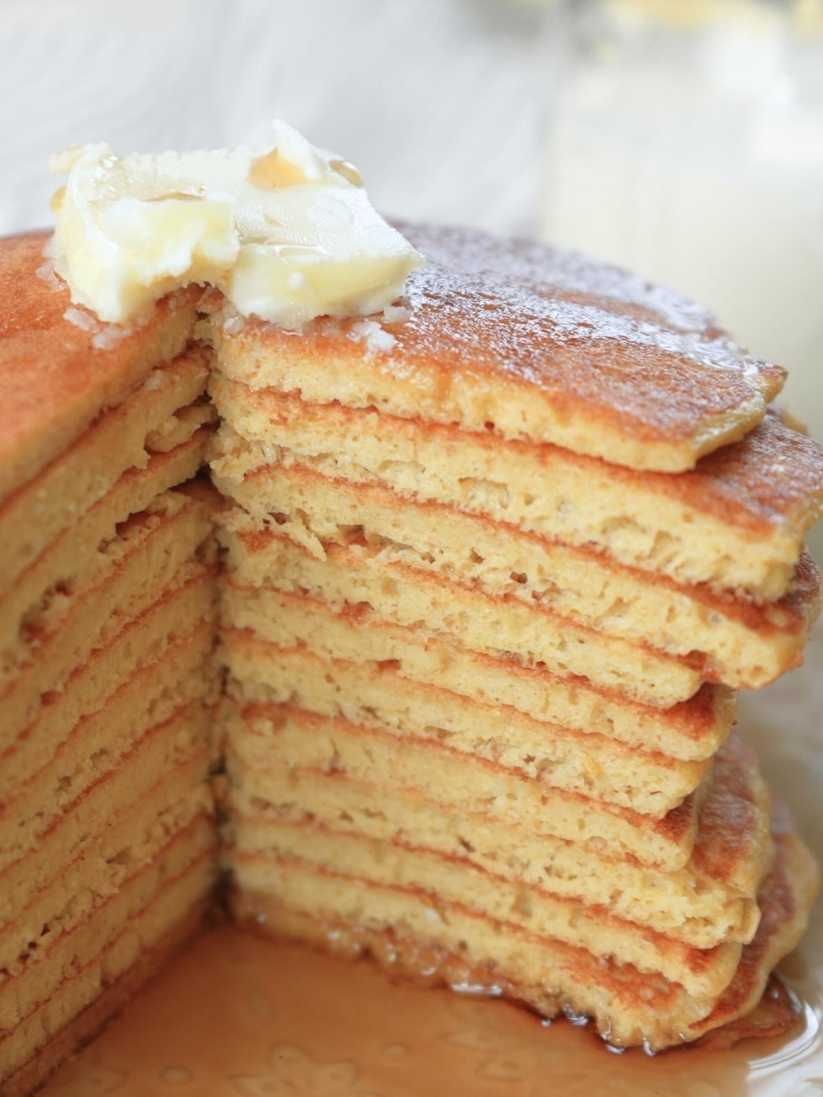 Stack of sourdough discard pancakes with a wedge removed.
