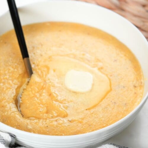 Southern cheese grits with a pat of butter in a bowl