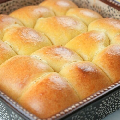 Pull-apart sourdough brioche rolls in a baking dish