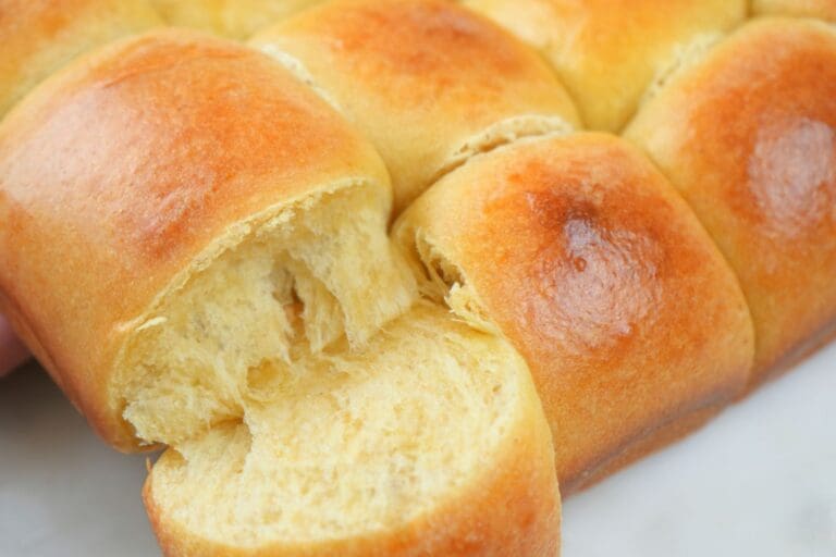 Pull-apart sourdough rolls, with a corner roll pulled off