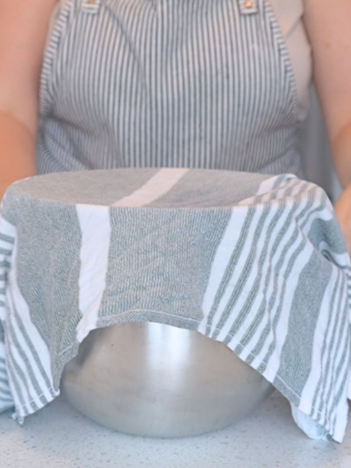 Mixing bowl covered with a damp towel.