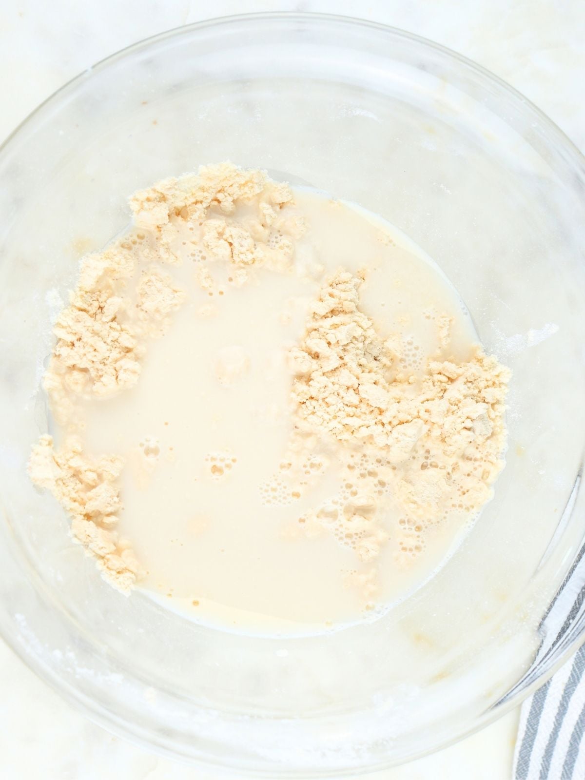 Starter-water mixture poured into the dry ingredients.