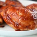 Instant Pot BBQ chicken thighs on a white plate