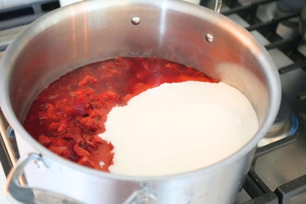 Strawberries, sugar, and lemon juice in a stainless steel stock pot