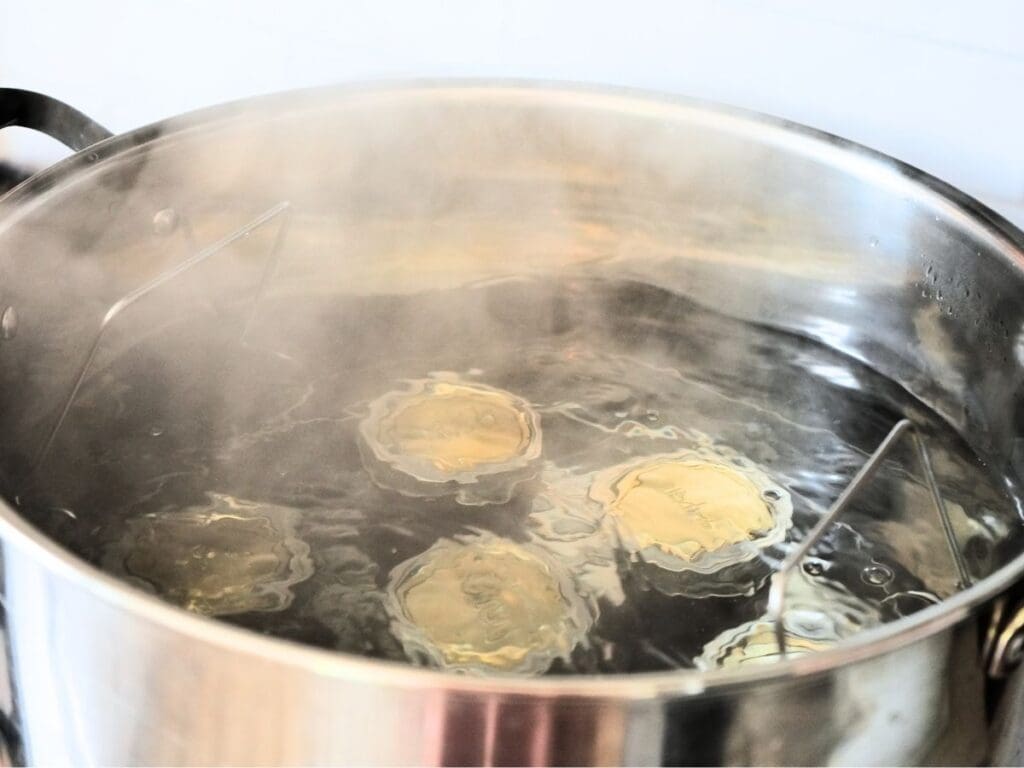 Jars of canned strawberry jam in a water bath canner.