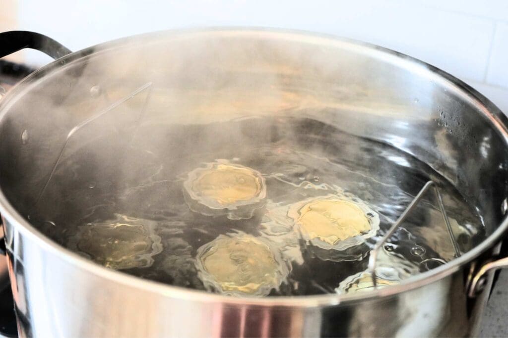 Jars of canned strawberry jam in a water bath canner