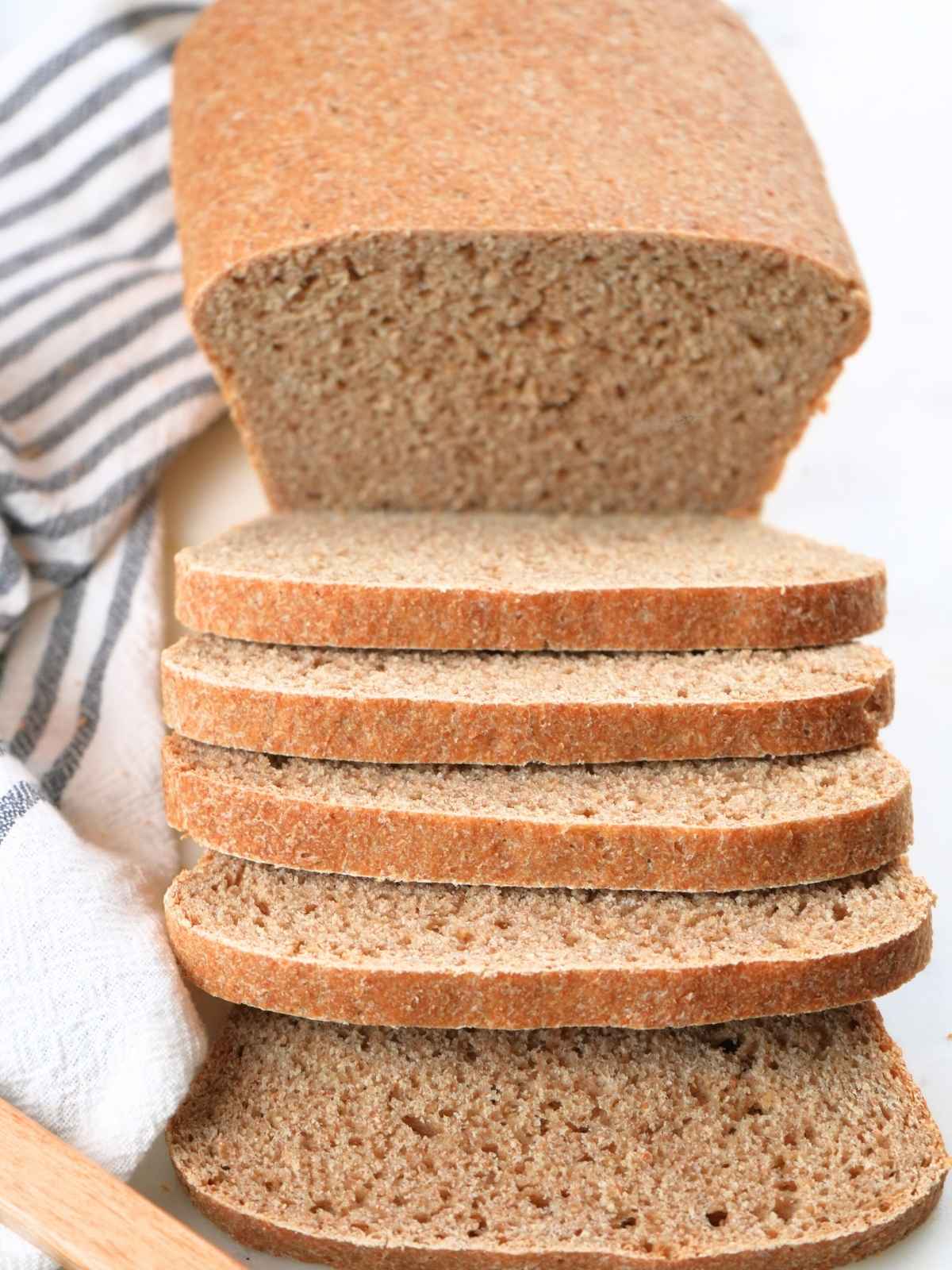 A loaf of fresh-milled sourdough sandwich bread with slices