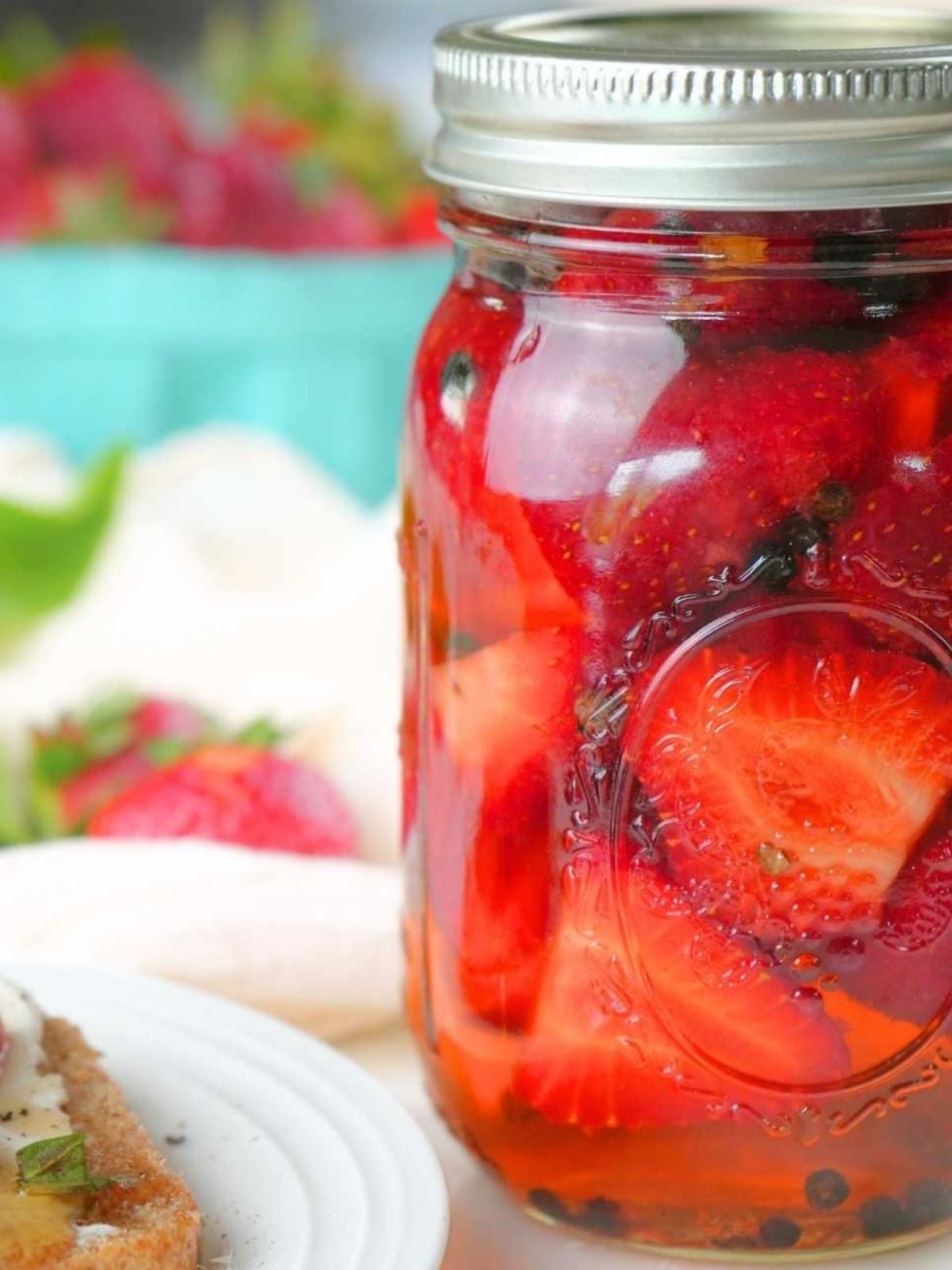 Picked strawberries in a glass jar.
