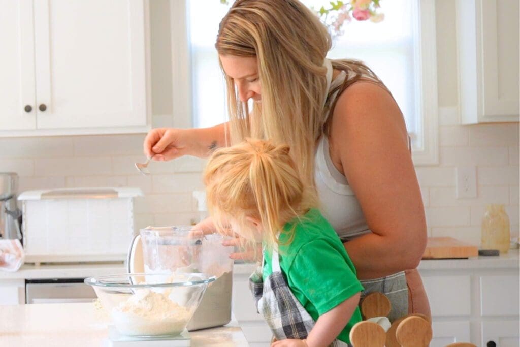 A mom and daughter making sourdough bread together