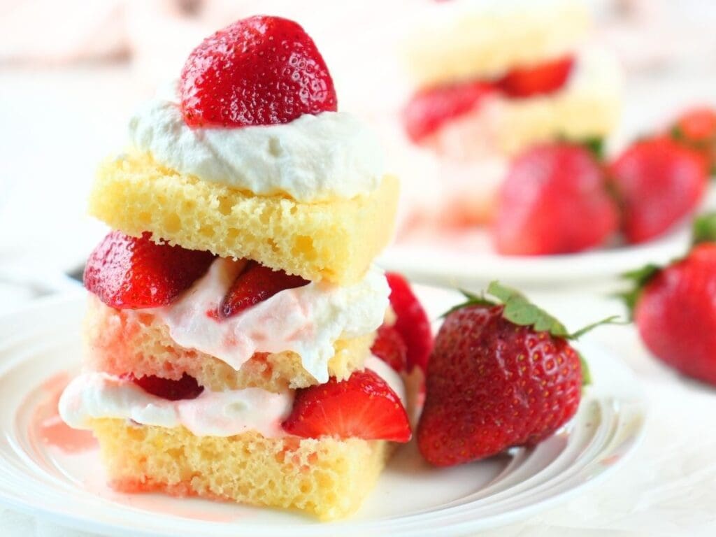 Sourdough strawberry shortcake on a plate with fresh berries.