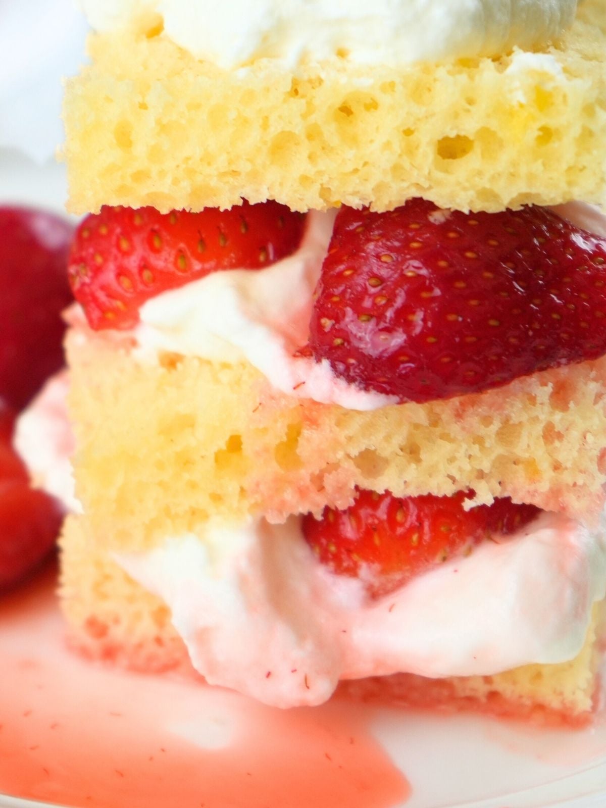 Sourdough strawberry shortcake with syrup drizzled on the plate