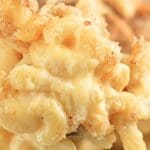 Close up of sourdough mac and cheese, showing the cheesy sauce and noodles.