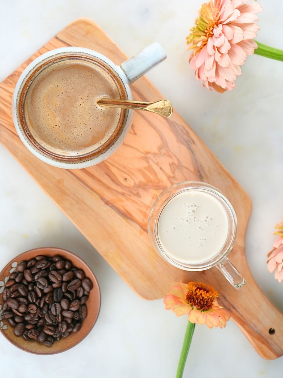 A cup of coffee and brown sugar coffee creamer on a tray.