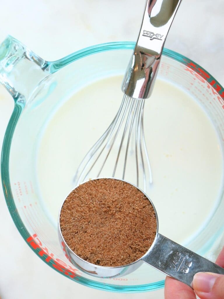 Brown sugar being added to the milk mixture.