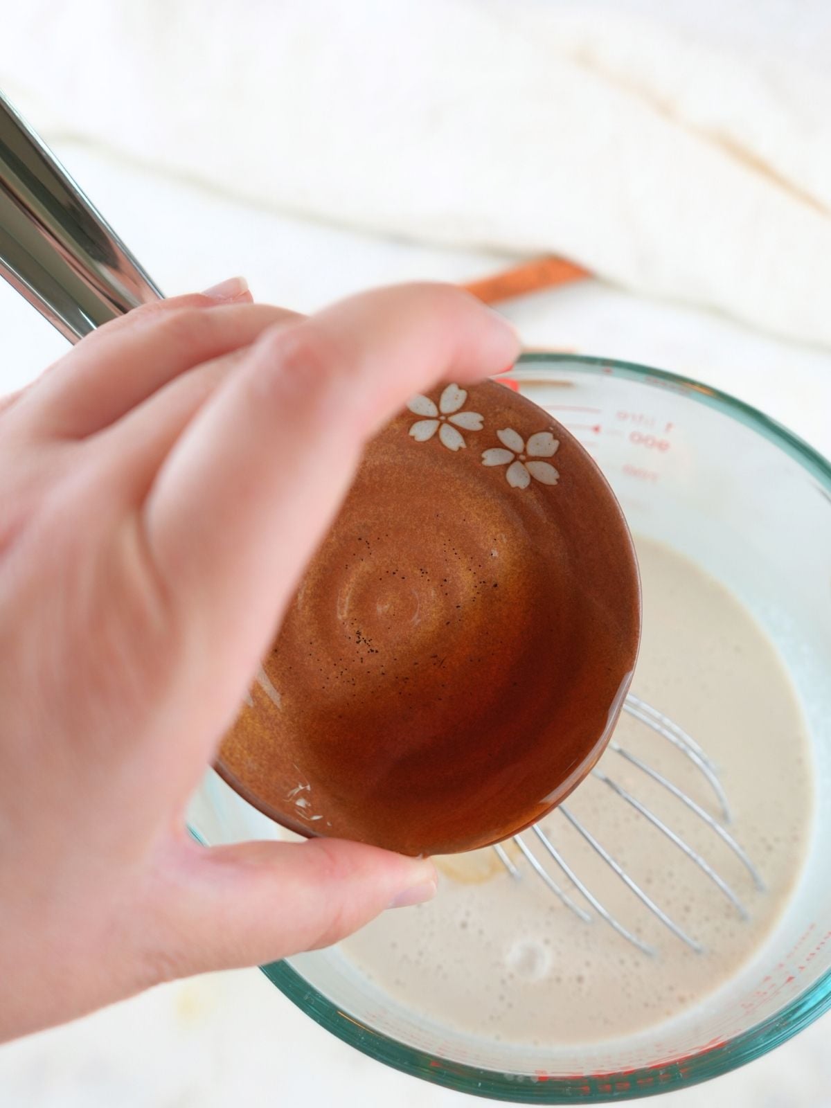 Vanilla being poured into homemade coffee creamer.