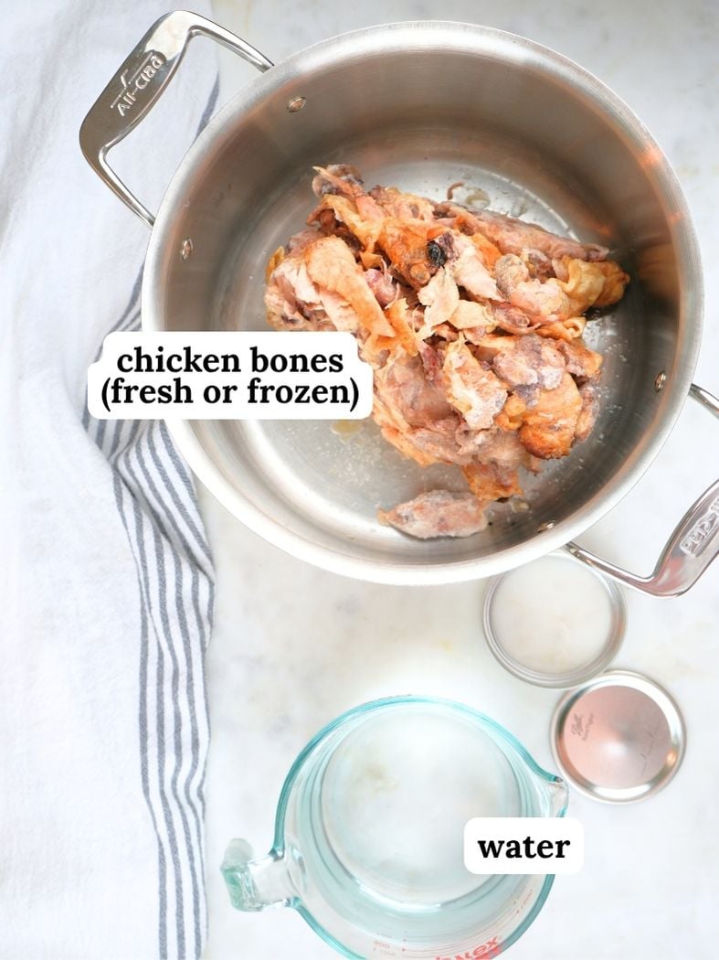 Chicken broth ingredients displayed and labeled: chicken bones (fresh or frozen) and water