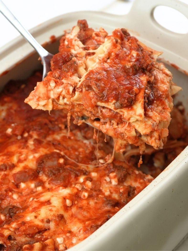 A spatula lifting a slice of slow cooker lasagna