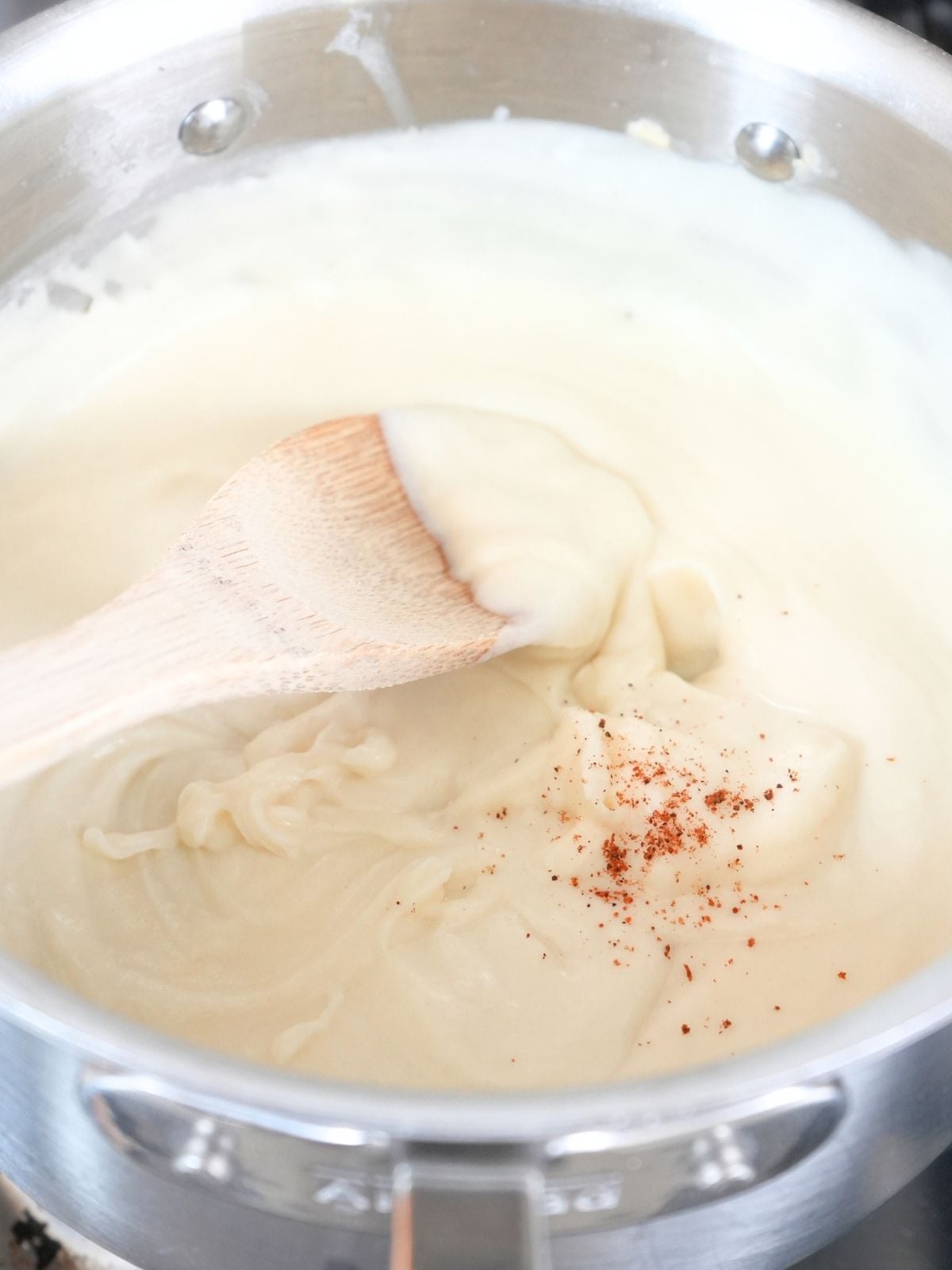 A pinch of nutmeg on a thick white sauce.