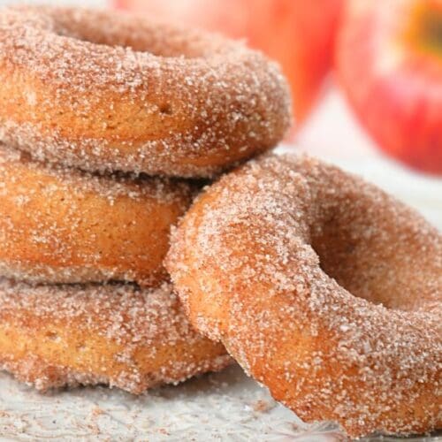 Close up of sourdough apple cider donuts stacked on a plate