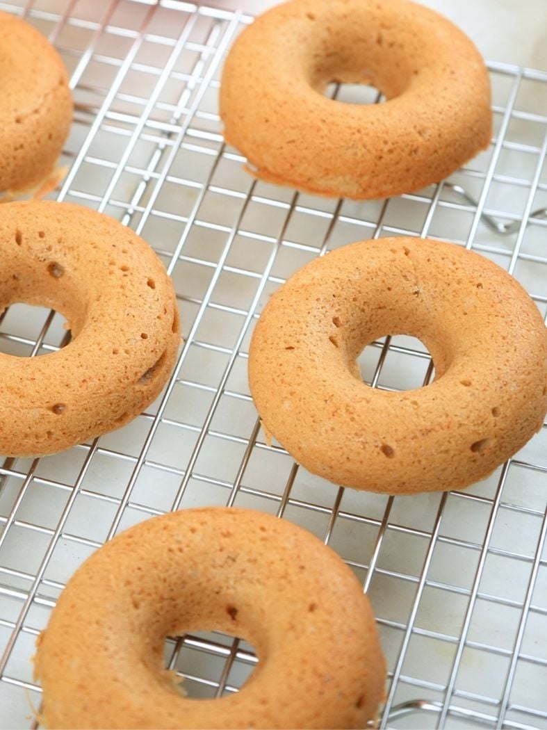 Baked donuts on a wire cooling rack