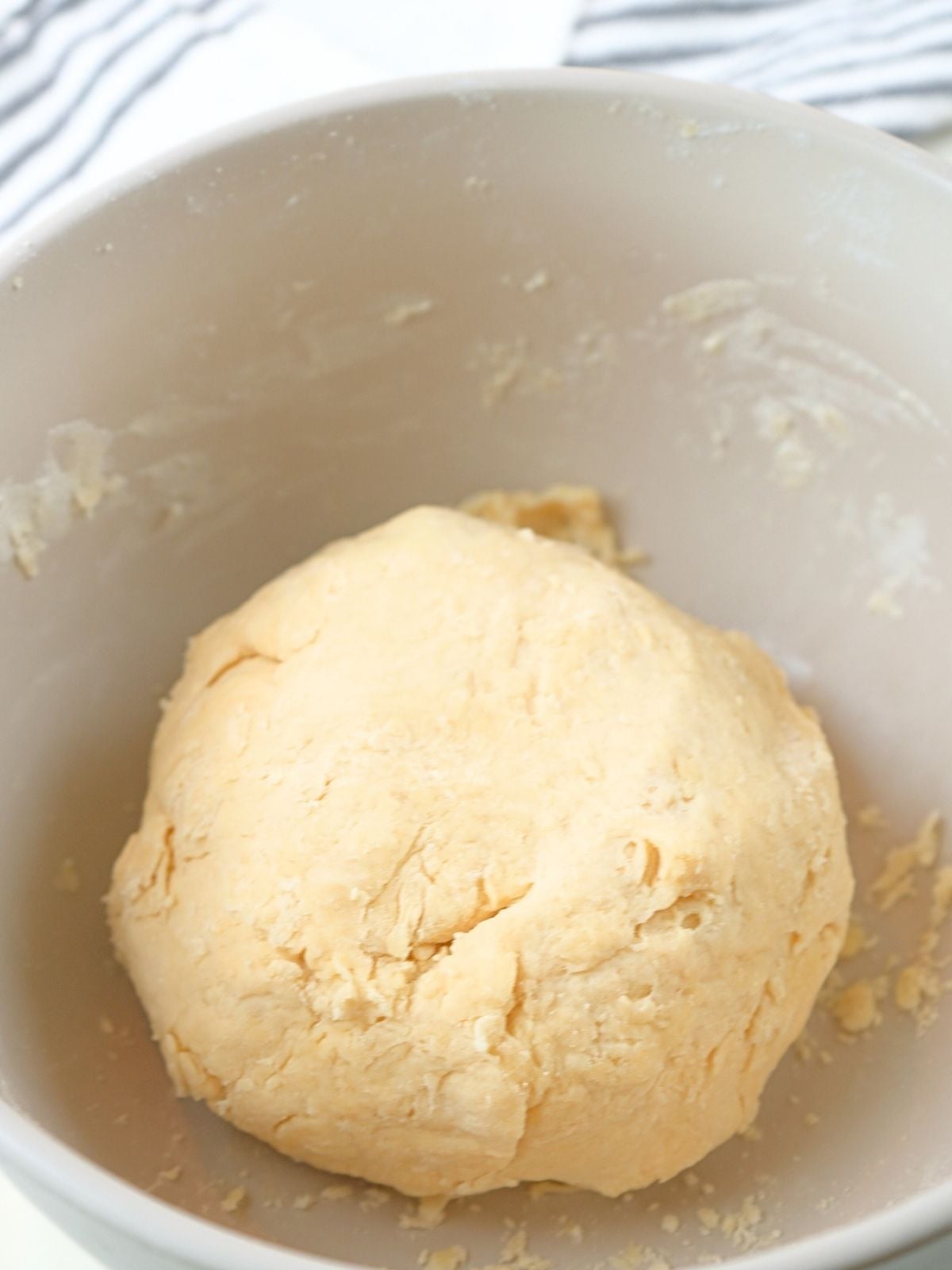 A ball of dough in a mixing bowl