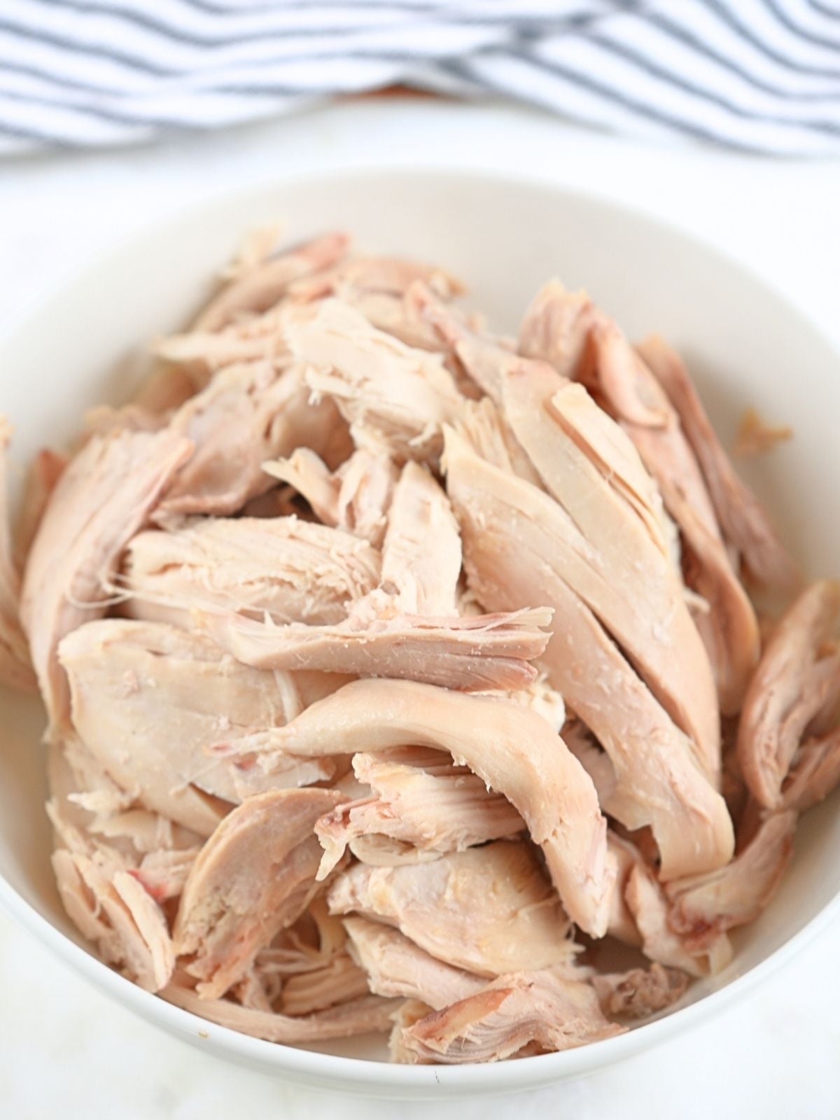 Shredded chicken in a bowl.