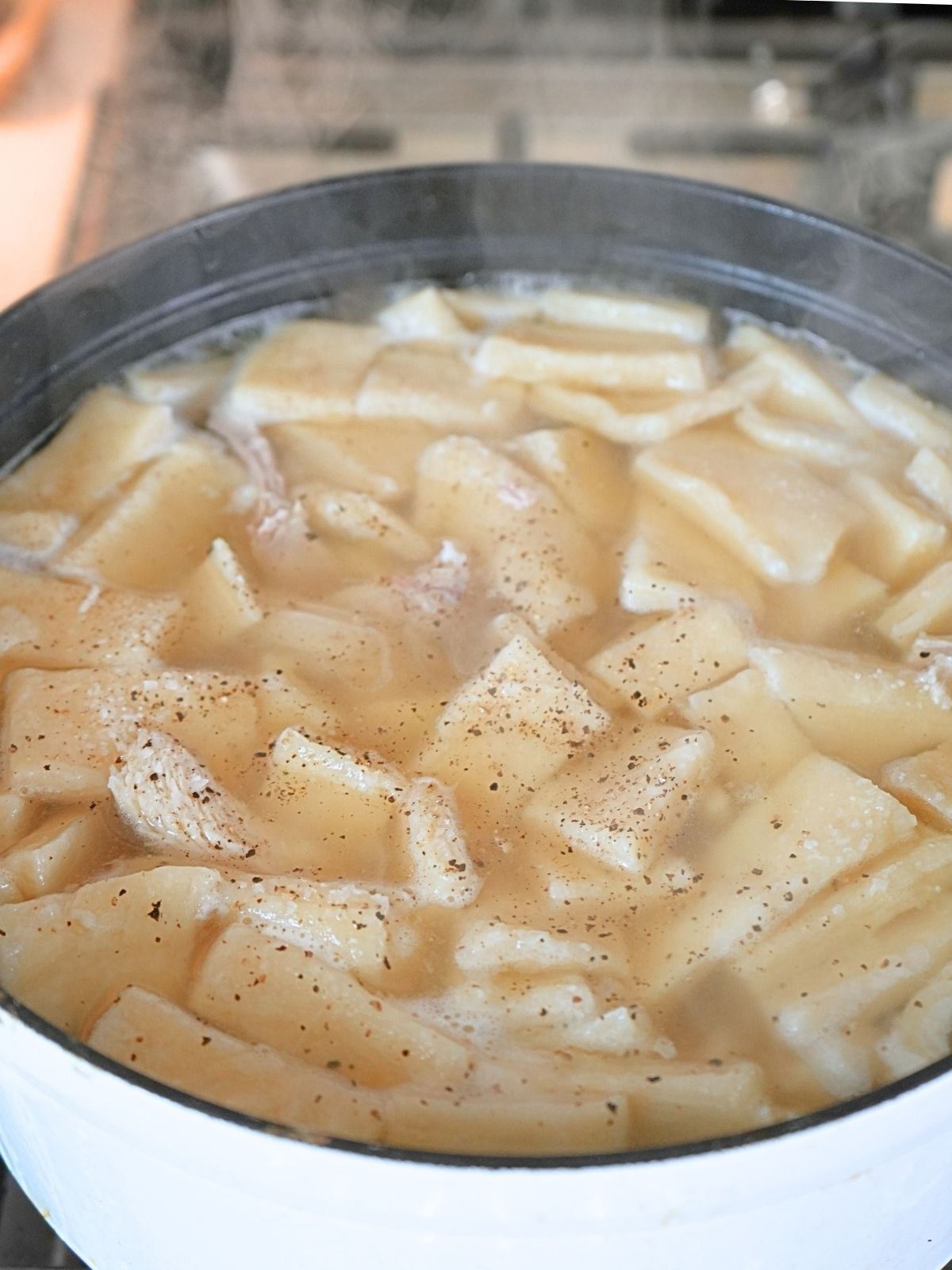 Broth, chicken and pastry boiling on the stove.