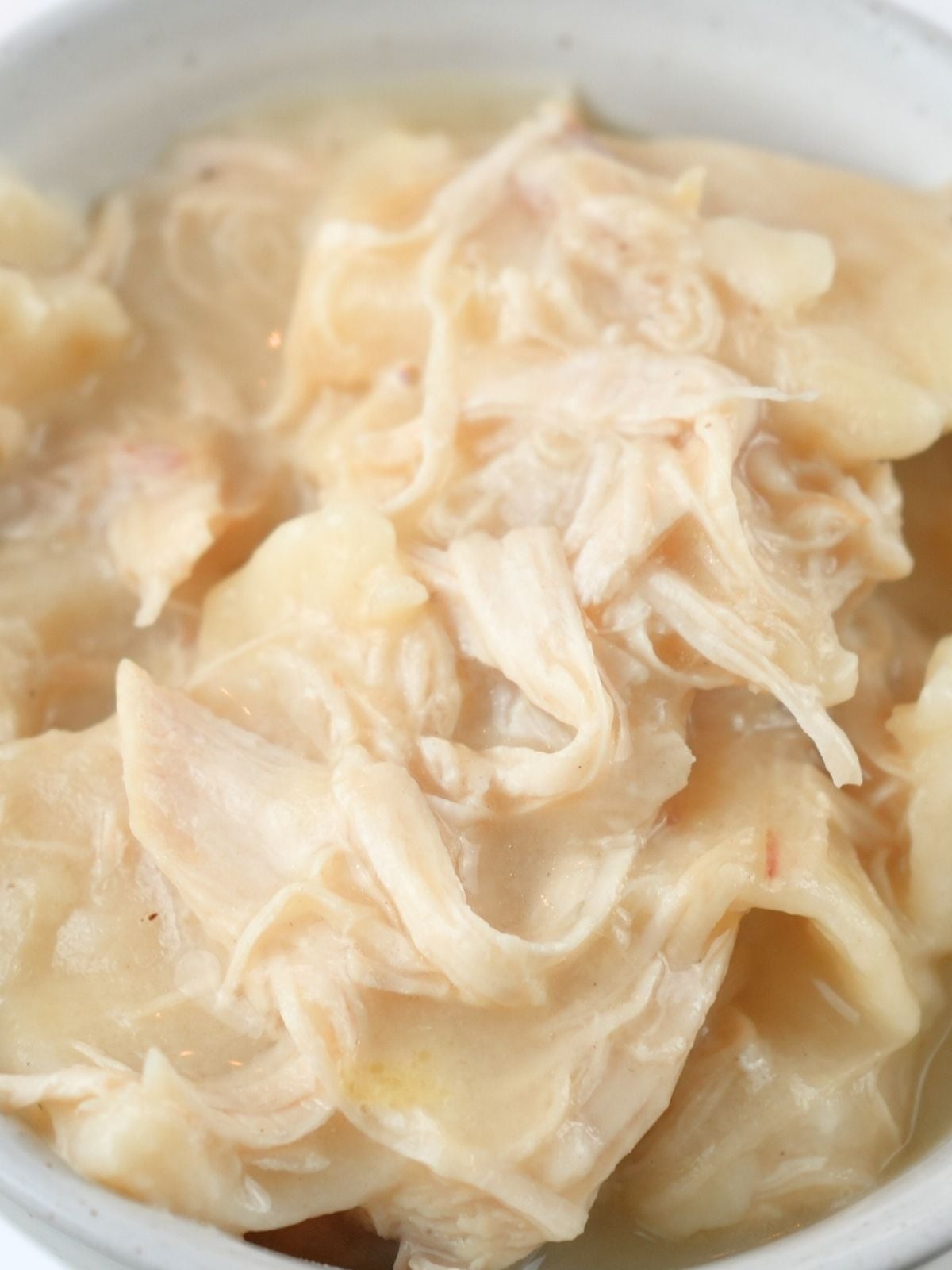 Cooked chicken and pastry in a bowl.