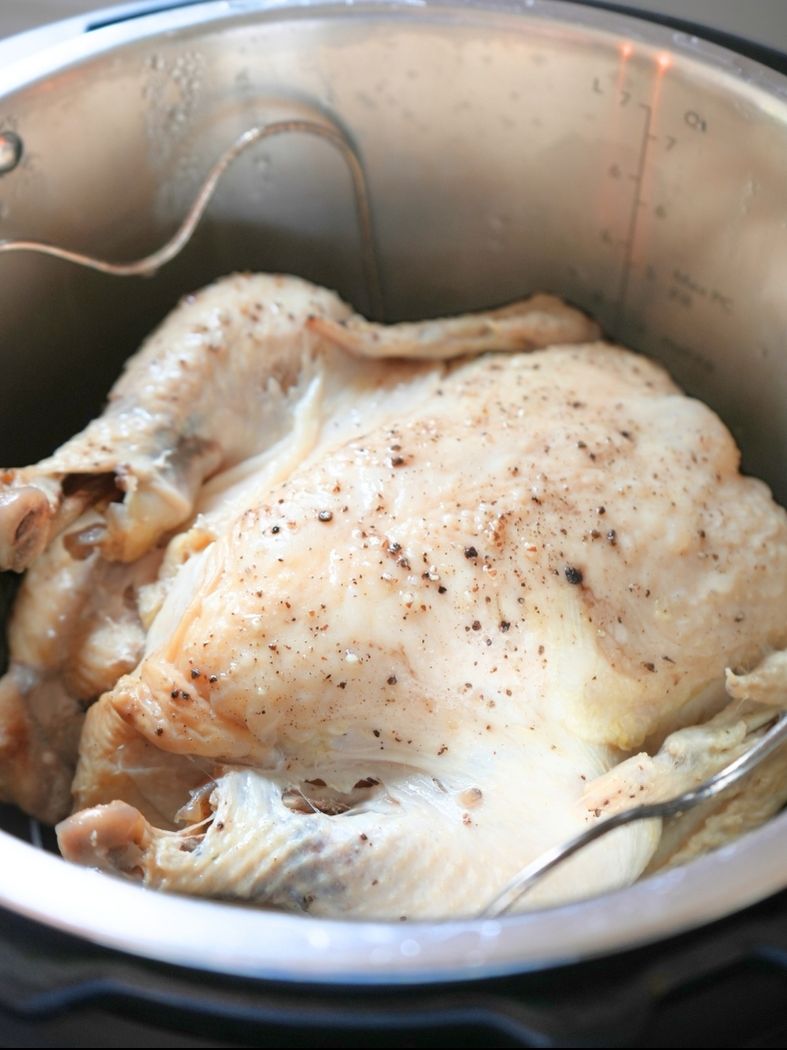 Overhead view of a cooked whole chicken in an Instant Pot