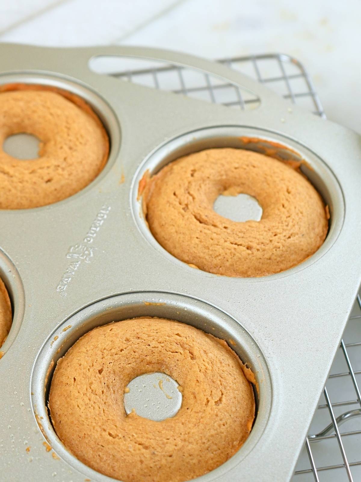 Baked donuts in a donut pan.