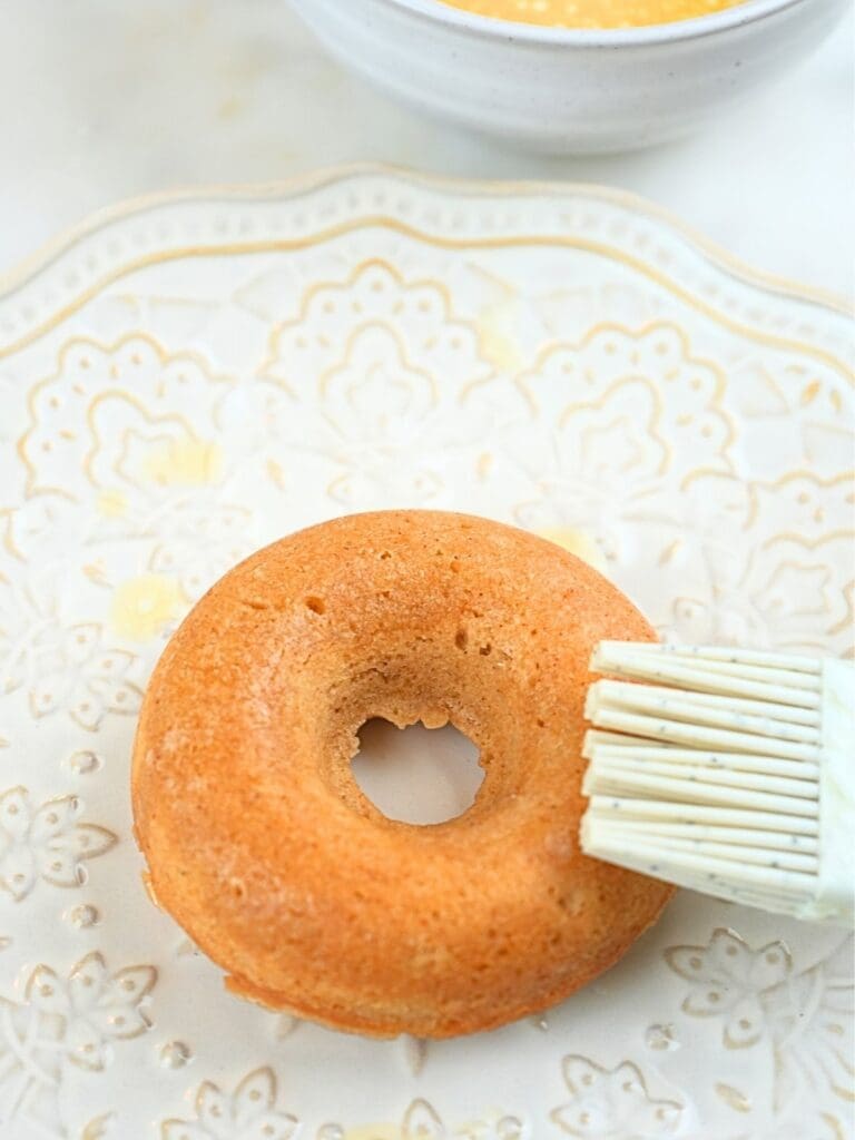 A silicone brush on a buttered donut.