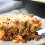 A scoop of shepherd's pie with corn, showing corn in the foreground