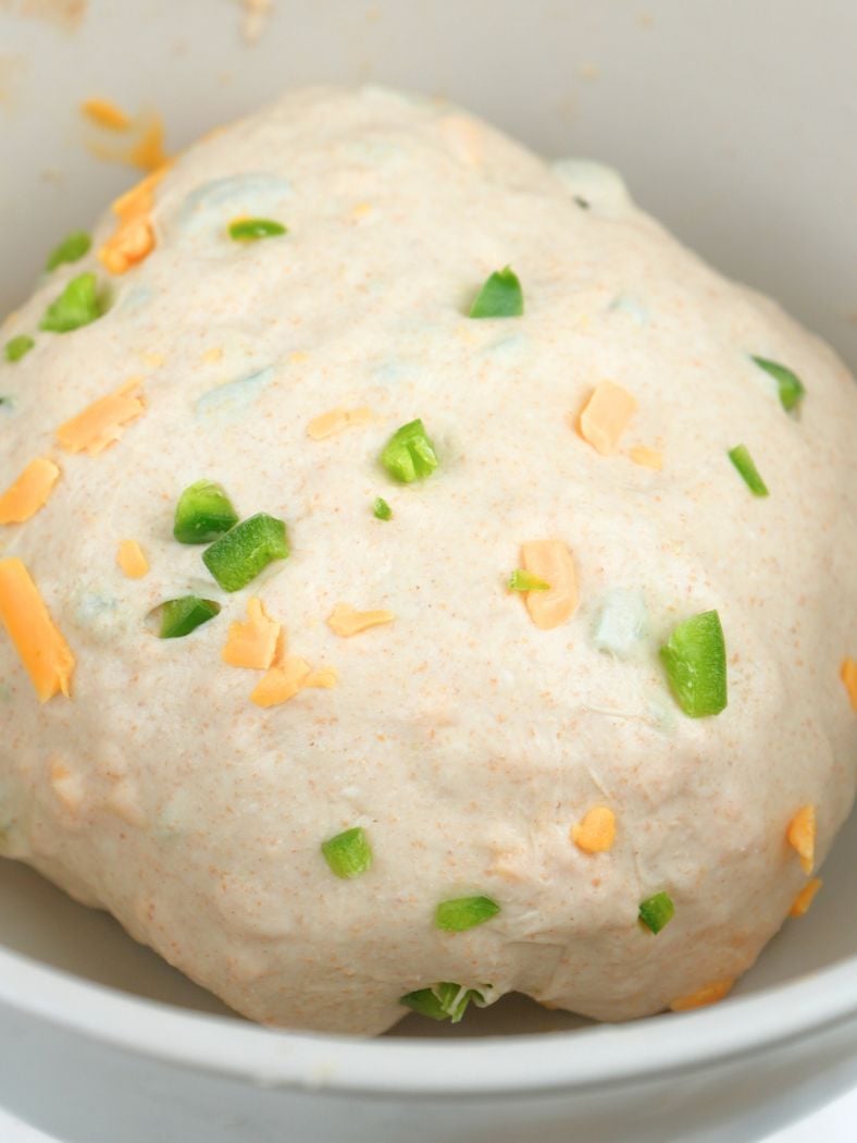 Sourdough cheddar jalapeños bread dough in a bowl, ready for bulk fermentation