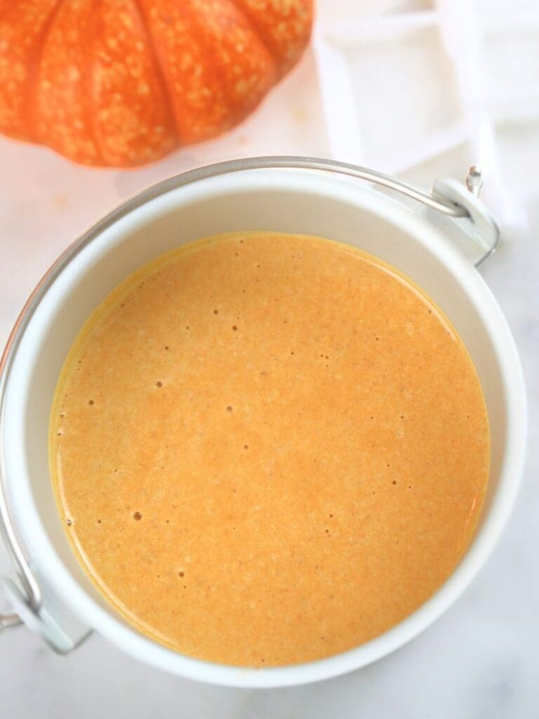 Ice cream maker container filled with pumpkin ice cream mixture