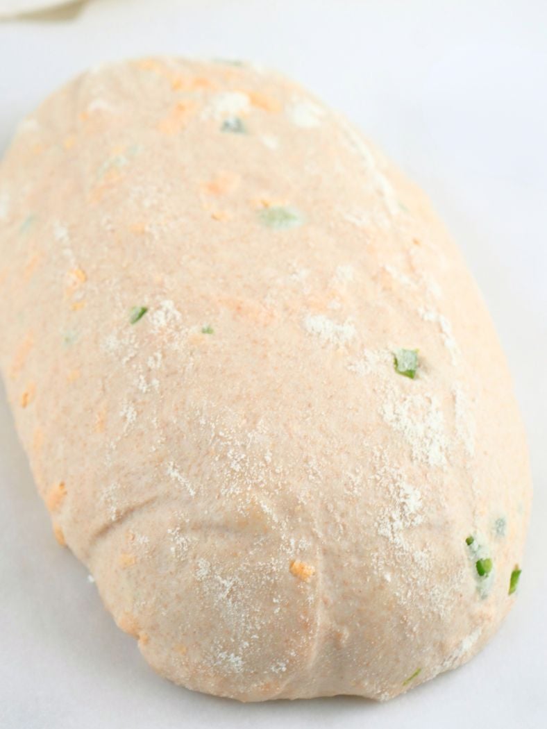 Proofed dough turned out on a a piece of parchment paper