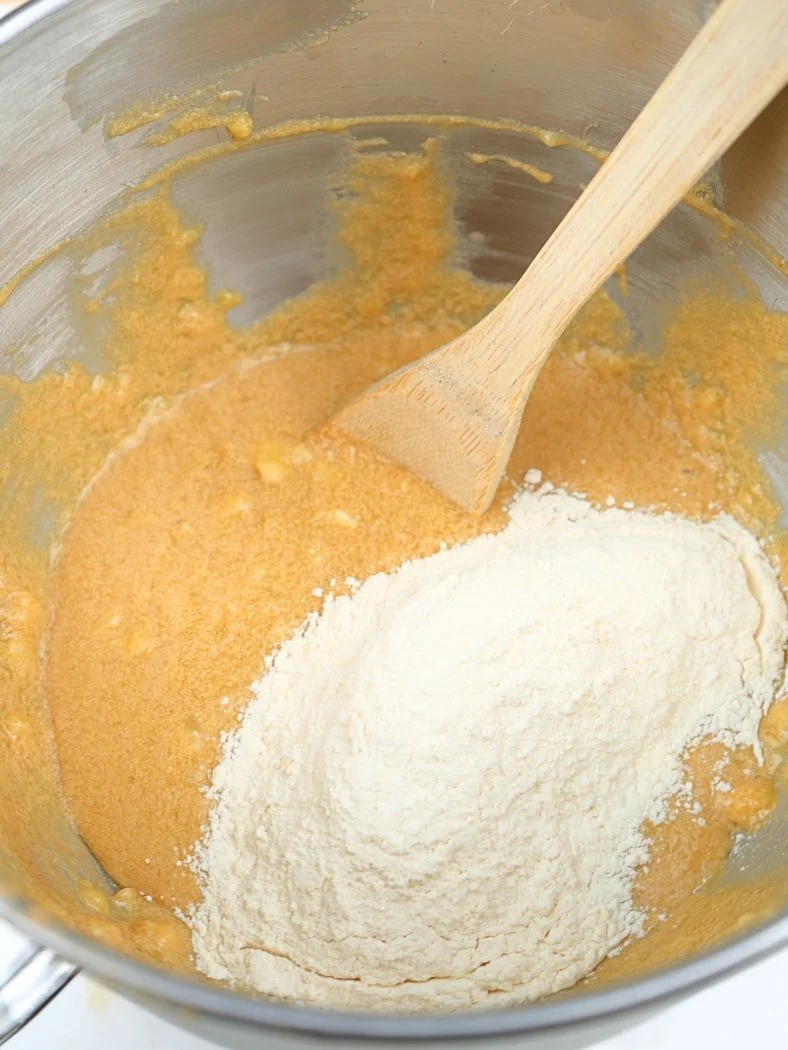 Flour on top of wet ingredients in a stand mixer bowl