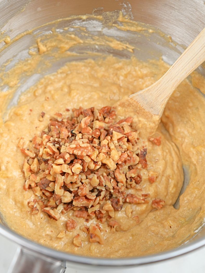 Sourdough banana bread batter with chopped walnuts on top