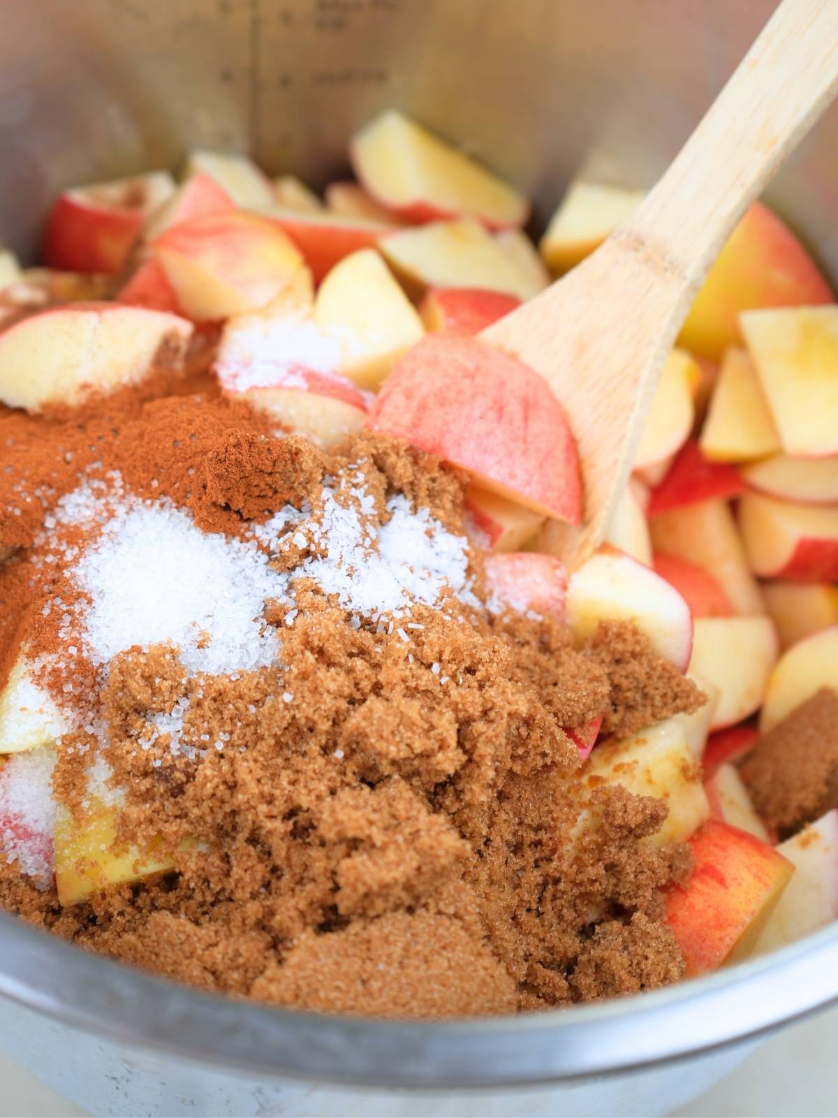 Brown and white sugar on top of chopped apples in an Instant Pot.